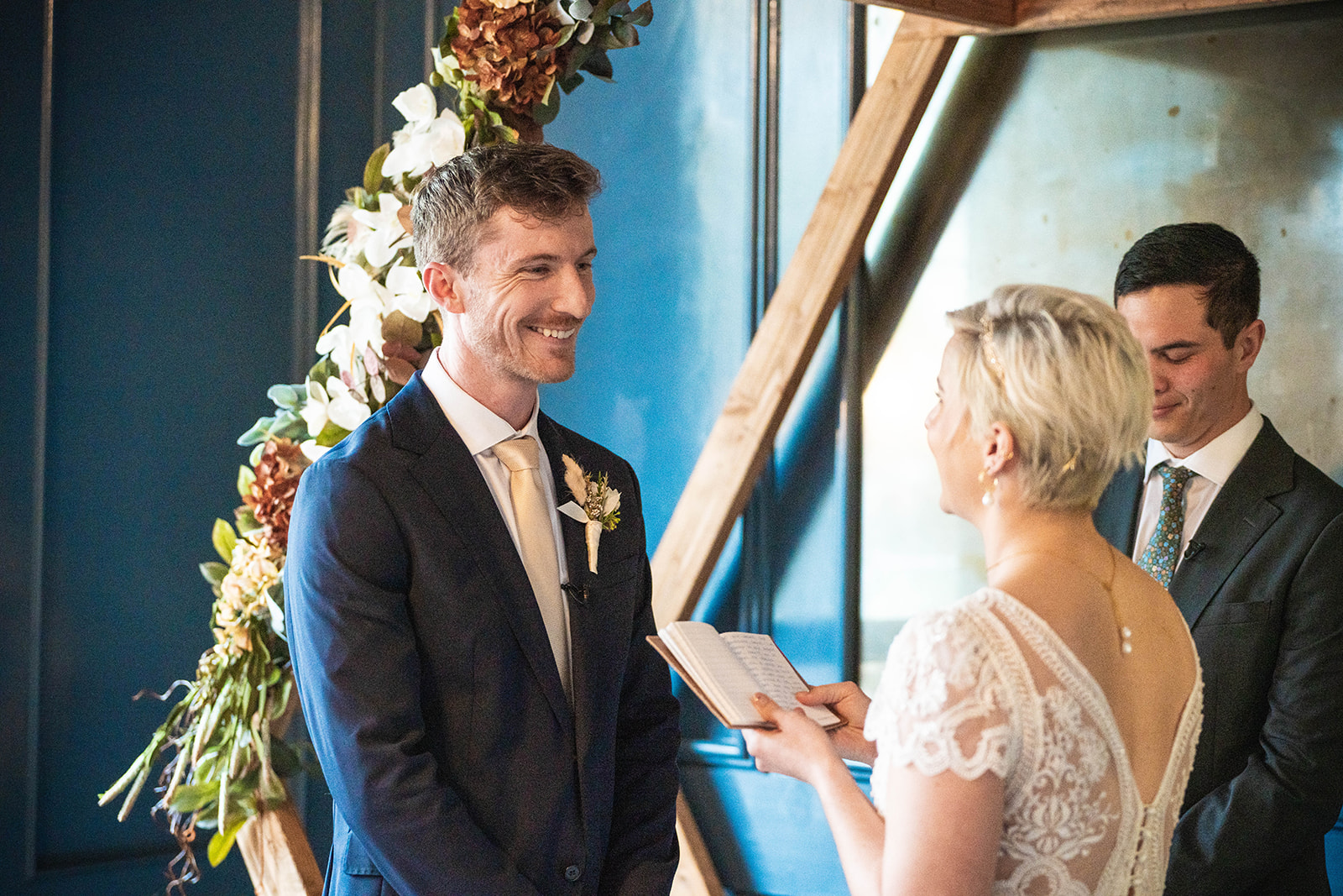 Couple exchanging vows at intimate indoor ceremony