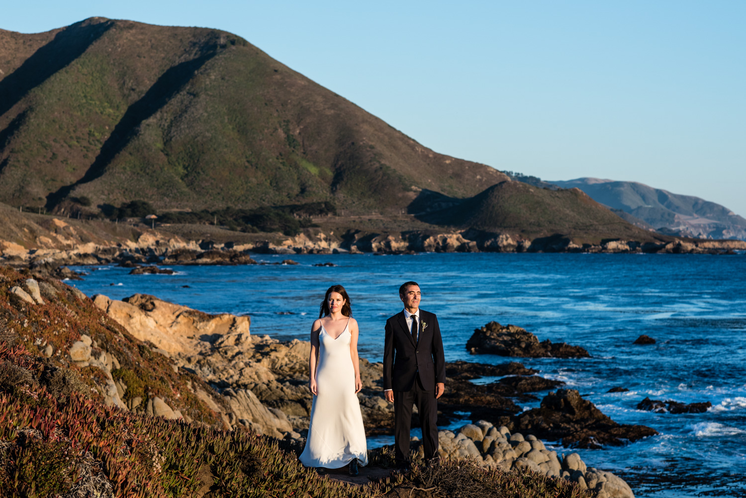 Couple standing together on Big Sur coastline