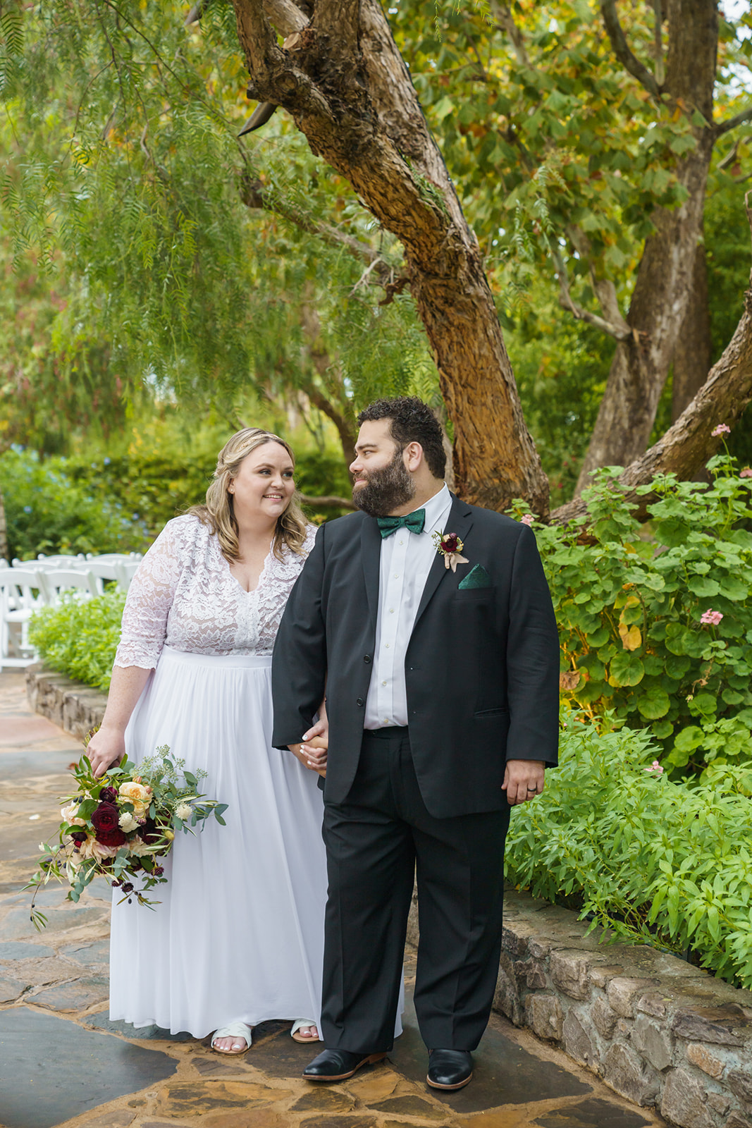 Happy couple walking through garden